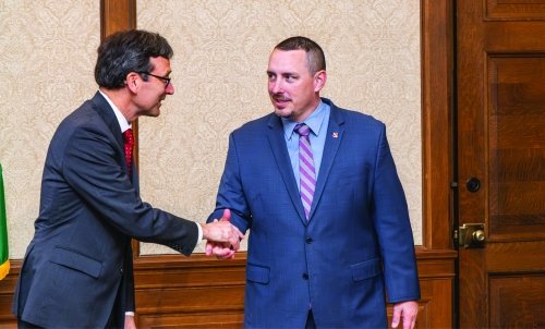 Joshua Penner shakes hands with an official