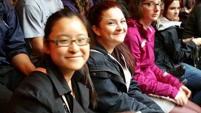 Students sit in a row at the Globe Theater