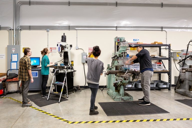 Mechanical engineering students working together on a lab project.