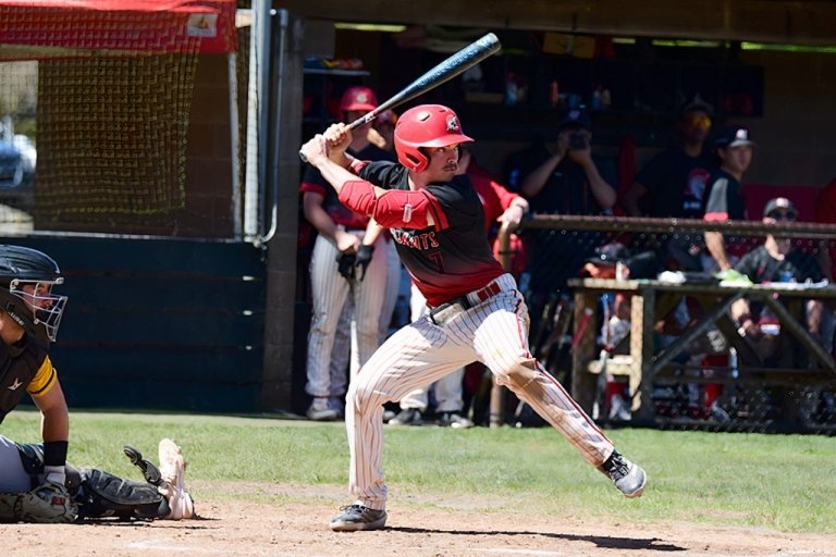 A Saints baseball player prepares to swing bat
