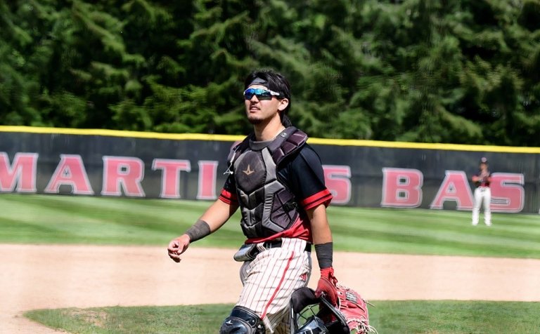 A Saints baseball player on field with gear