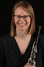 Photo of Lyndi Knox, holding their clarinet
