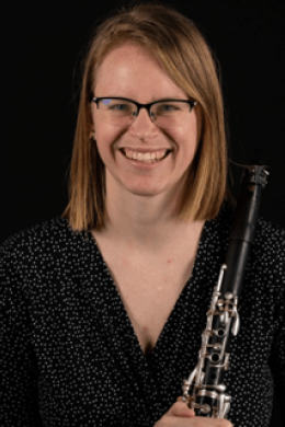 Photo of Lyndi Knox, holding their clarinet