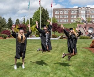 Graduating students jumping