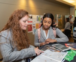 Photo of student signing up in career fair