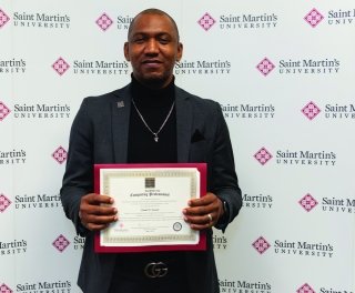 A graduate displays his diploma.
