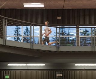 Photo of student running on indoor track
