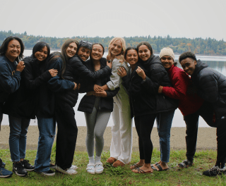Benedictine Scholars pose in front of a lake