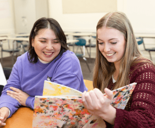 Students browse children's books in Literature and Arts Integrations with Professor Celeste Trimble