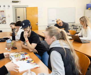 Students browse children's books in Literature and Arts Integrations with Professor Celeste Trimble
