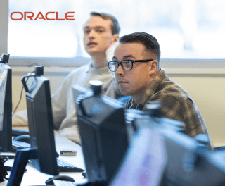 Students at computers with the Oracle logo overlaid