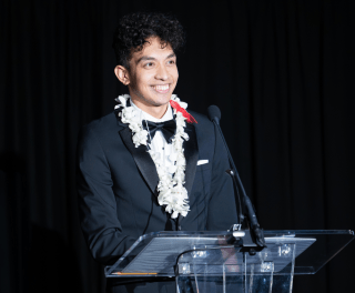 A student speaks form a lectern at Gala