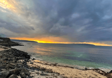 The sun rises over a tempestuous coastline