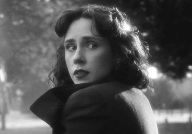 Black and white dramatic shot of a woman's face outside