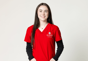 Student in red scrubs