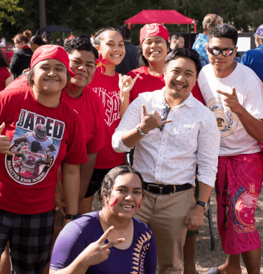 Students wearing mostly red smile at Picnic on the Plaza