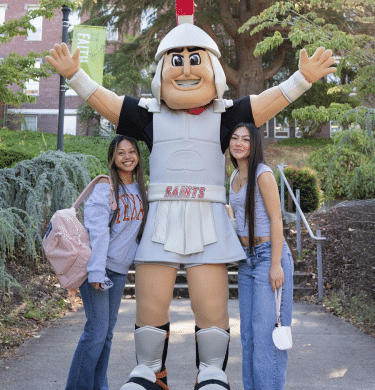 Marty the Mascot poses with two students outside