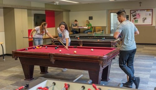 Commuter students playing pool in the Trautman Union Building lounge