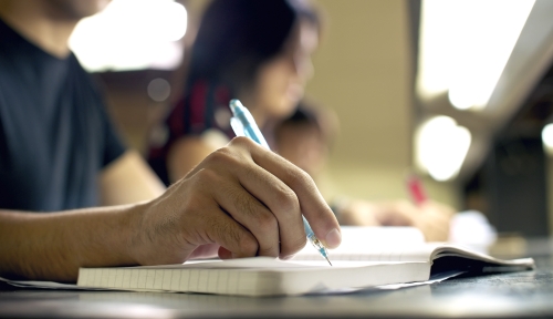 Stock photo of a student writing