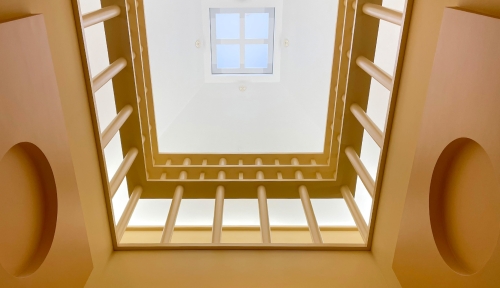 Looking up in the atrium of the library--shows the railing from the floor above and the ceiling.