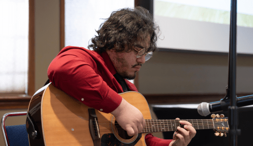 A students plays guitar