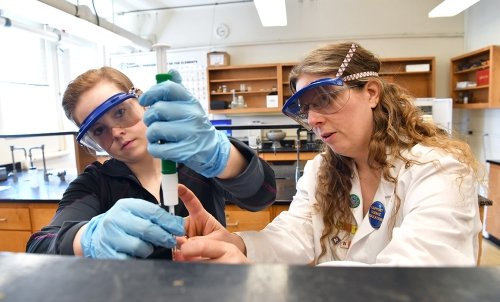Professory Arwyn Smalley instructs a student in the safe and proper use of equipment.