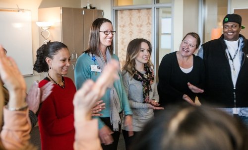 AcademicProgram_psychology_02-22 SMU Career Counseling-2.jpg Students and instructors stand in a circle, smiling and clapping.