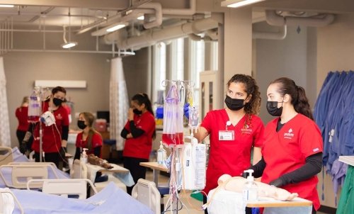 Nursing students work through a lesson in the SMU nursing lab