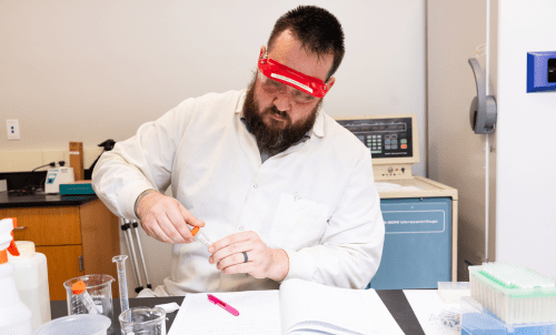 A student works with equipment in a lab
