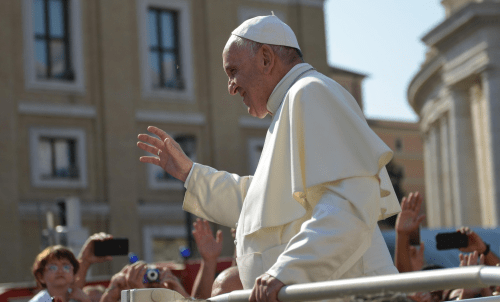 Pope Francis waving to a crowd.
