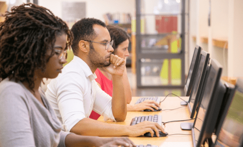 Students work at computers in a row