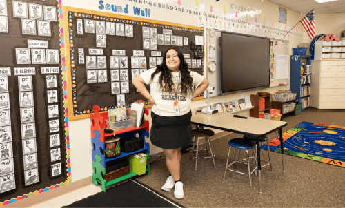 A student stands in an elementary school classroom
