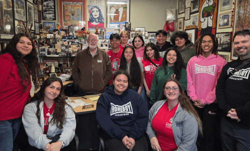 Students and staff pose with Fr. Gregory Boyle in his office