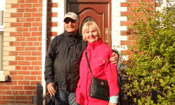 Tom and Pat Barte in front of a brick building
