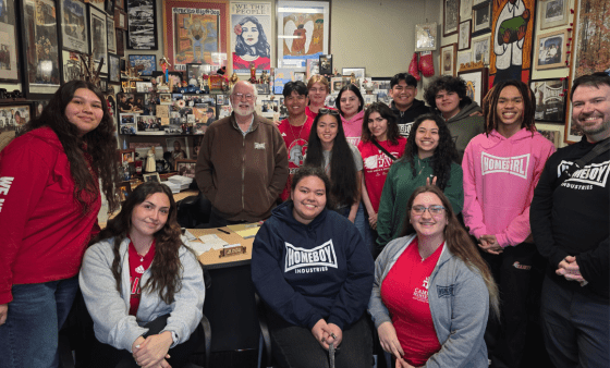 Students stand with Fr. Greg Boyle in his office at Homeboy Industries
