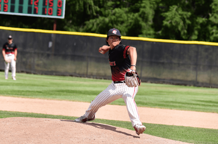 A Saints baseball player prepares to pitch
