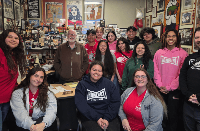 Students and staff pose with Fr. Gregory Boyle in his office
