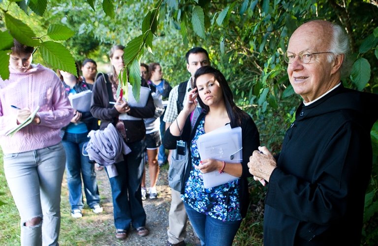 Photo of monk with students outdoors