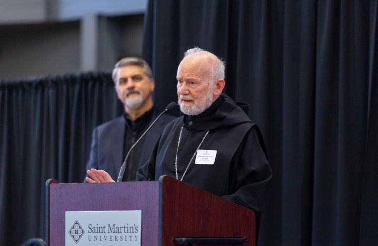 Photo of Benedictine monk speaking on podium