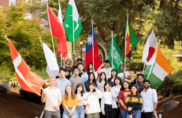 International students hold national flags outside