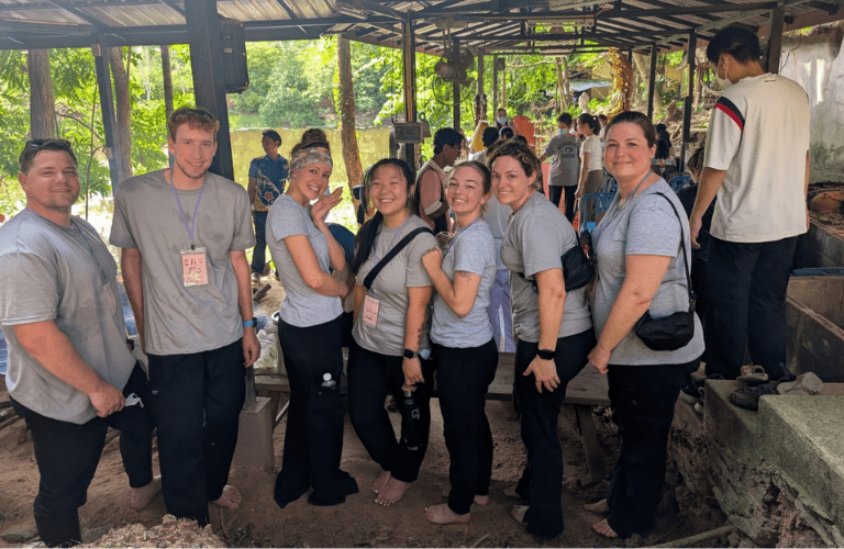 Students and faculty pose in international setting