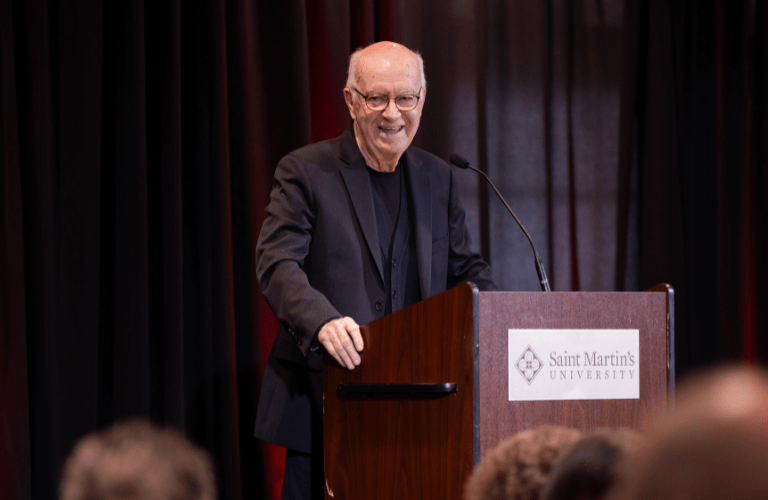 Fr. Kilian speaks from a podium