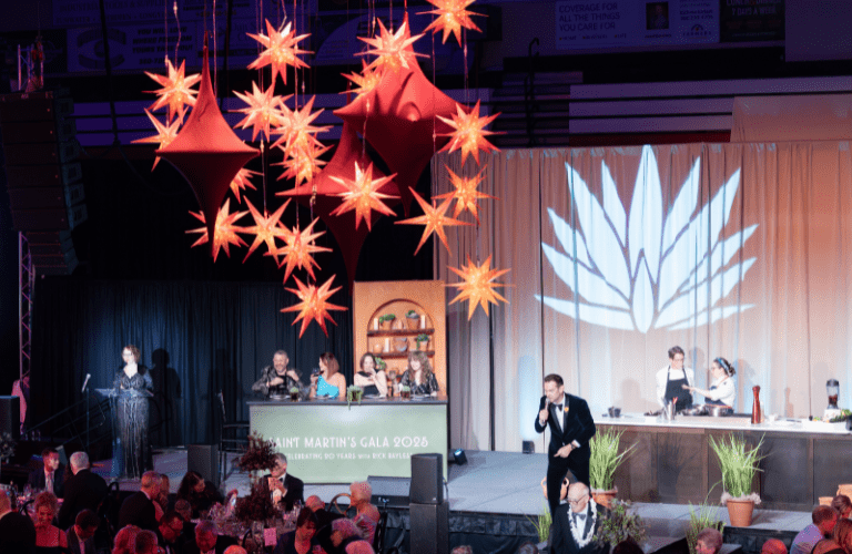 The setting and stage of Gala with the chef on stage and the audience in formalwear