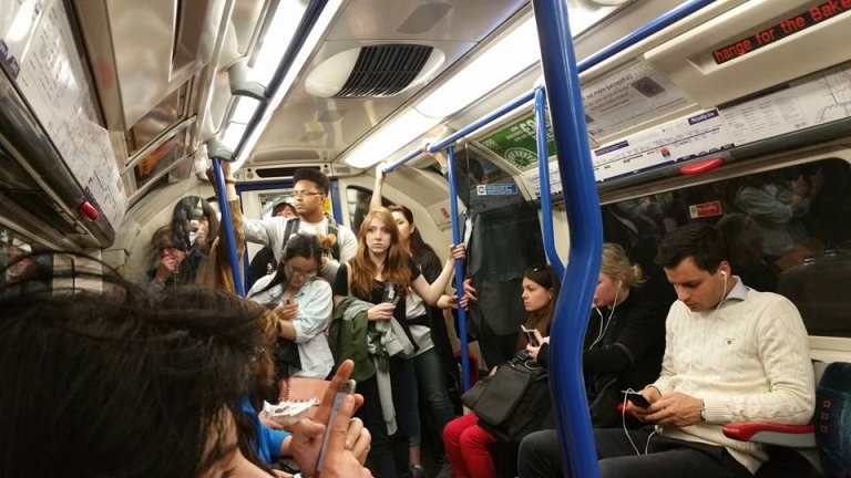 Students and Londoners ride the Tube in London