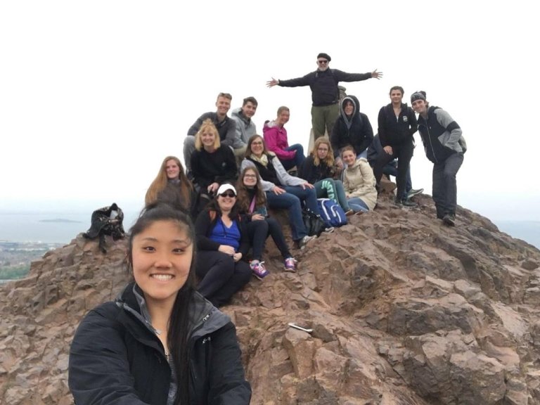 Students and faculty on a hilltop in Edinburgh
