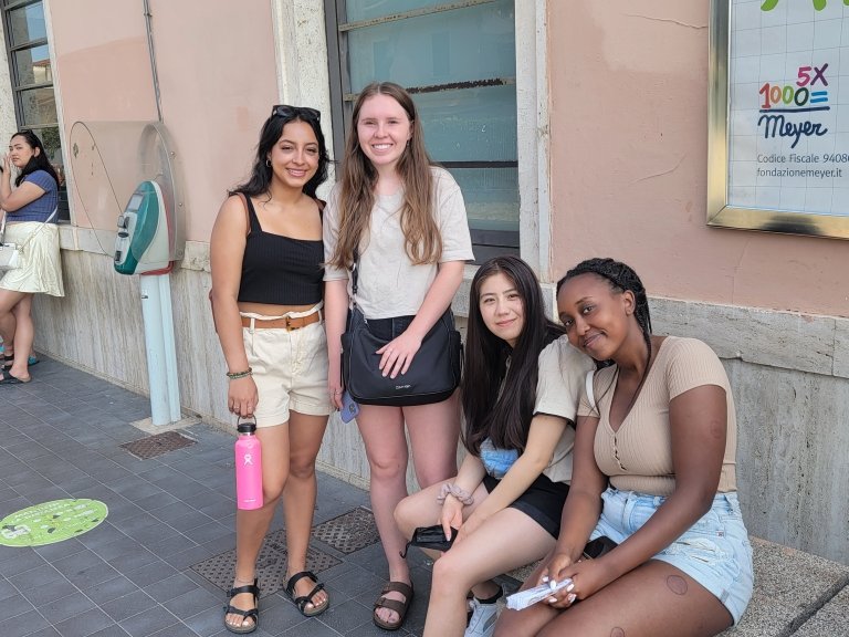 Students pose on a street in Italy