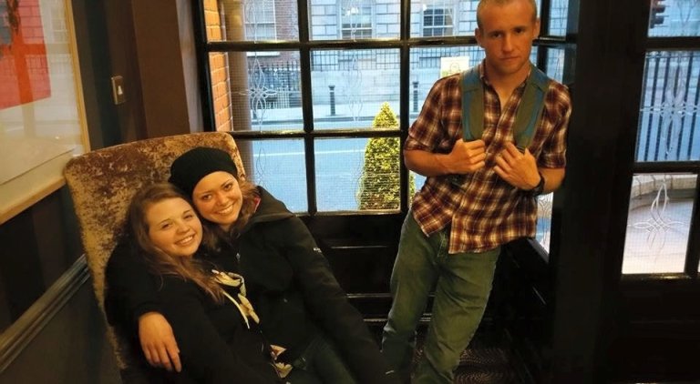 Students resting in the lobby of a London bed and breakfast