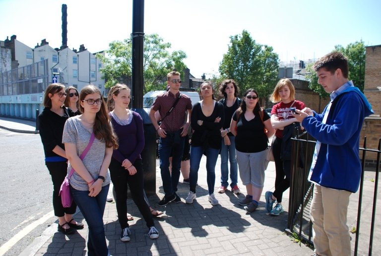 Student reading a crowd of fellow students on a street in Whitechapel, London