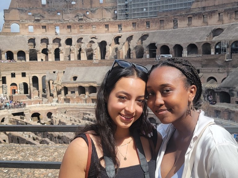 Two students post in front of the Colosseum