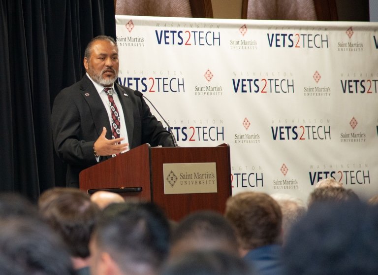 Washington Veterans to Technology special ceremony. Speaker is at the podium on stage.